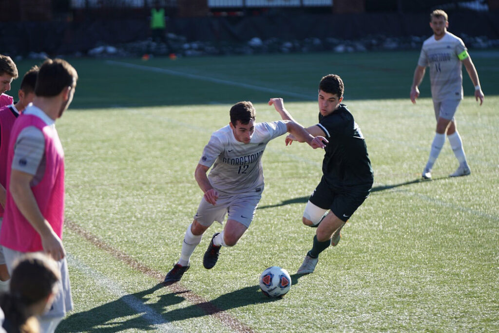 A group of men playing soccer on a field, promoting eye health and raising awareness about common eye diseases.