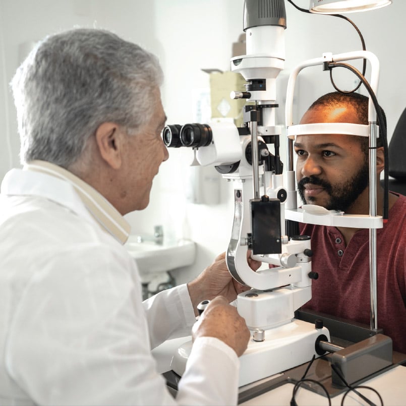 A man is having his eyes examined by an optometrist.